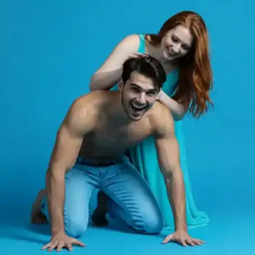 Man in a dog-like pose with a woman standing behind him, symbolizing the toxic relationship dynamics associated with certain zodiac signs.