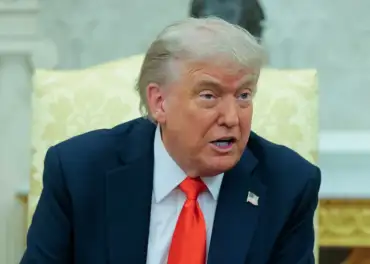 Donald Trump speaking with a strained expression during a heated moment in a public appearance.