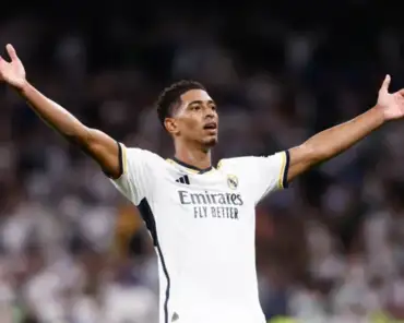 Jude Bellingham raises his arms during a Real Madrid match, as off-pitch controversies mount.